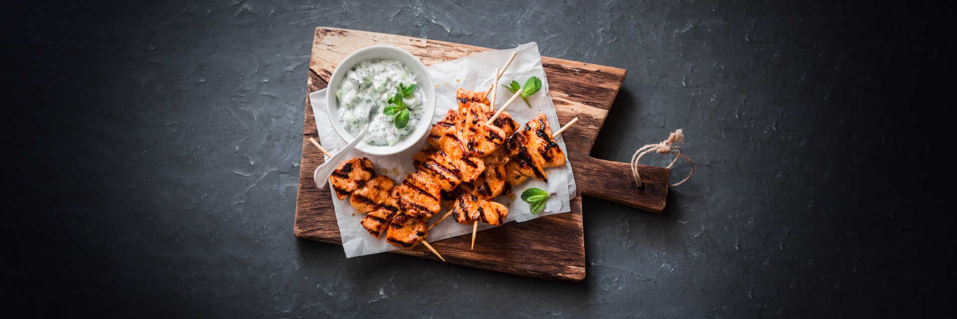 Healthy chicken kebabs on a wooden chopping board