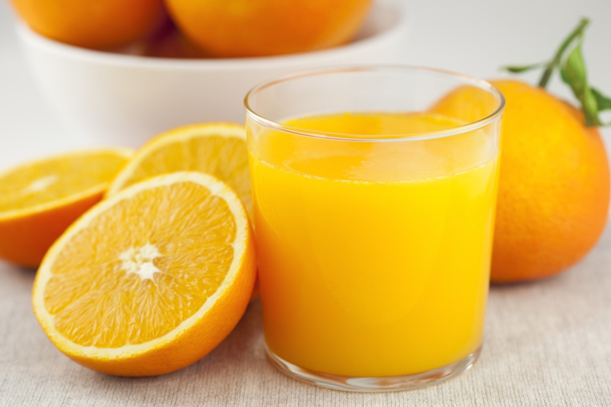 Glass of orange juice with oranges